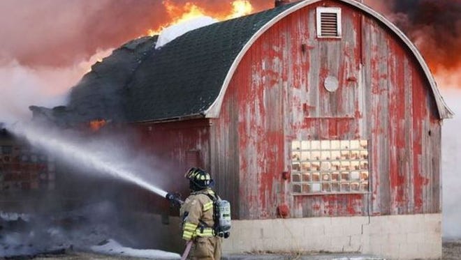 A firefighter battles a blaze in sub-zero temps on this farm near Brandon. The fire in Calumet township is the third fire in Fond du Lac Co. where farm buildings have been destroyed.