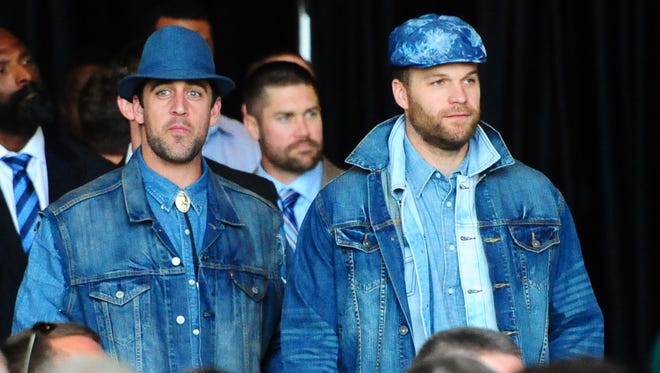 Green Bay Packers quarterbacks Aaron Rodgers, left, and Matt Flynn wear denim at the 51st annual Packers Homecoming Luncheon at Lambeau Field Atrium on Aug. 27, 2014.