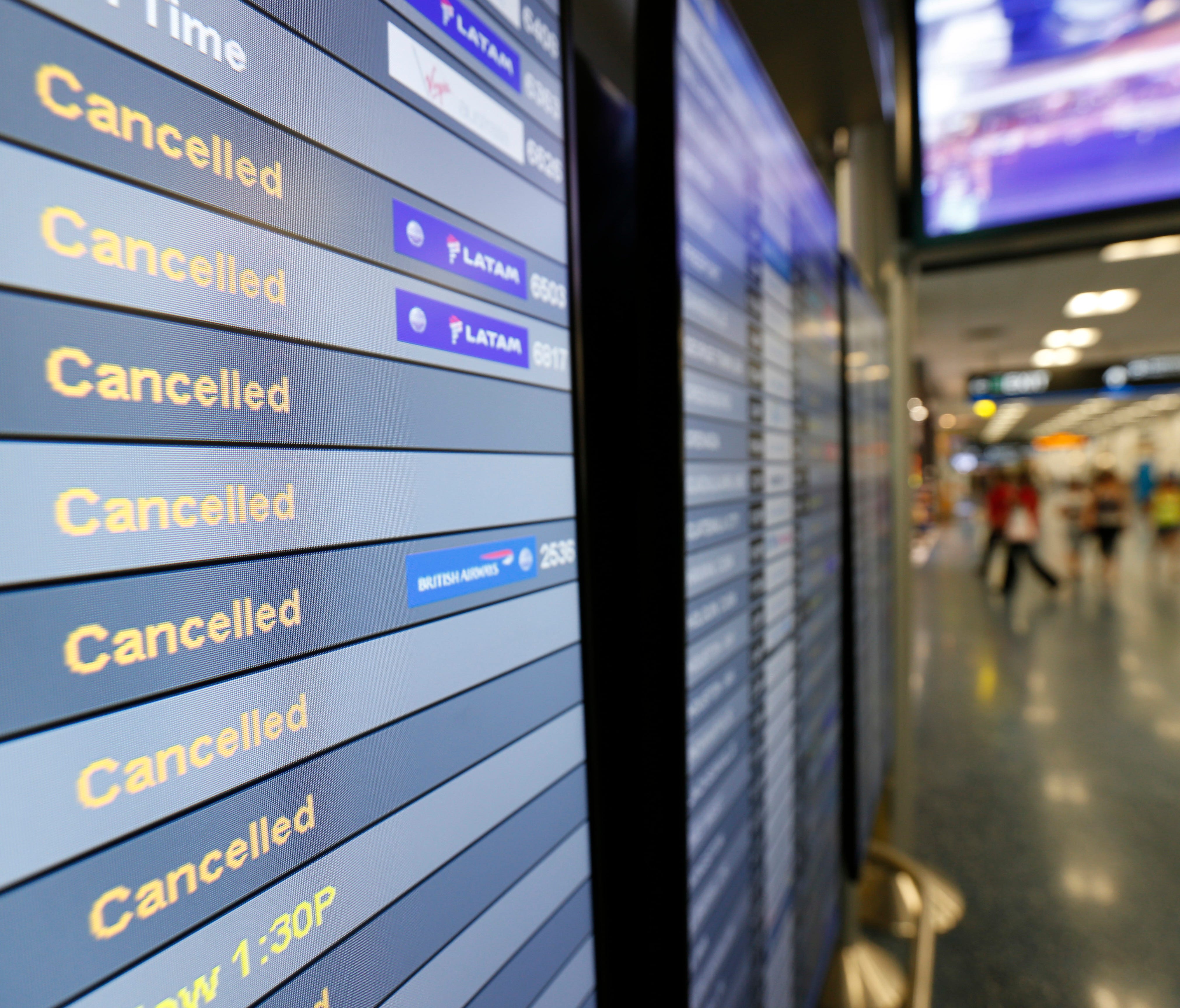 A monitor shows canceled flights at Miami International Airport on Friday, Sept. 8, 2017.