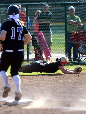 Lexington High School's Candace Maness makes a diving catch in foul territory for an out during game 7 of the DI-AA softball tournament game against Christian Academy of Knoxville, Wednesday, May 21, 2014.