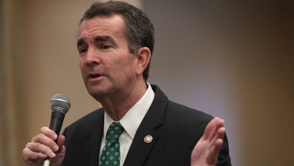 Ralph Northam speaks to residents during a visit to