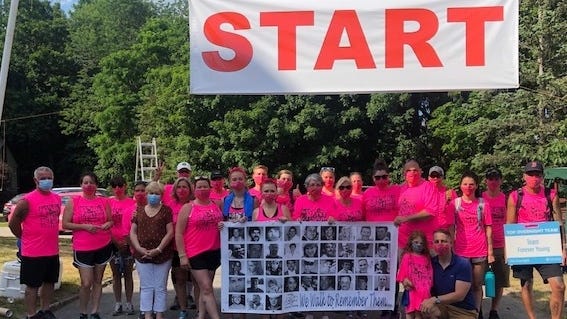 Participants posed for a photo at the start of the Team Forever Young Out of the Darkness walk, held June 20, in a 10-mile circuit to and from organizer Nancy Cook's Westford home. The Out of the Darkness Walk, held by teams nationwide, raises funds for the American  Foundation for Suicide Prevention.