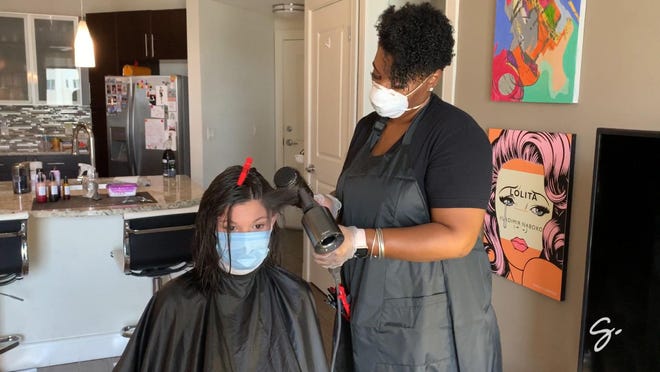 A Glamsquad stylist blows out a client's hair during a recent visit. The company, which offers in-home, on-demand beauty services such as hair, nails and makeup, recently restarted services in South Florida. The business shut down in March amid the coronavirus crisis.