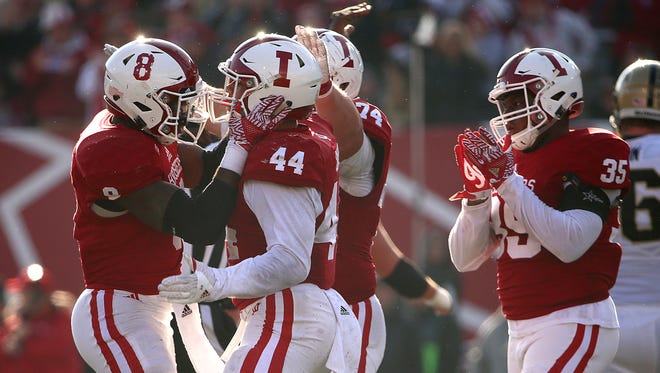 Indiana Hoosiers linebacker Tegray Scales (8) and Indiana Hoosiers linebacker Marcus Oliver (44) celebrate after Oliver sacked Purdue Boilermakers quarterback David Blough (11) leading to a fourth down, during second half action of the Oaken Bucket game between Indiana and Purdue at Memorial Stadium, Bloomington, Ind., Saturday, Nov. 26, 2016.