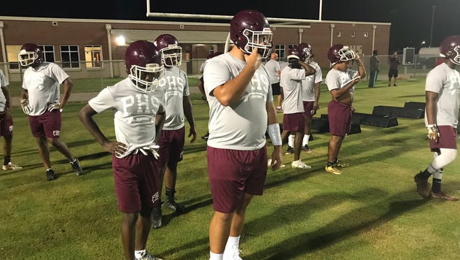 Hunter Rayburn leads his line during drills for Midnight Madness at Pensacola High. Teams across the state began football practices on Monday.