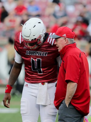 Louisville's Jawon Pass and Bobby Petrino talk before a play.  
April 13, 2018