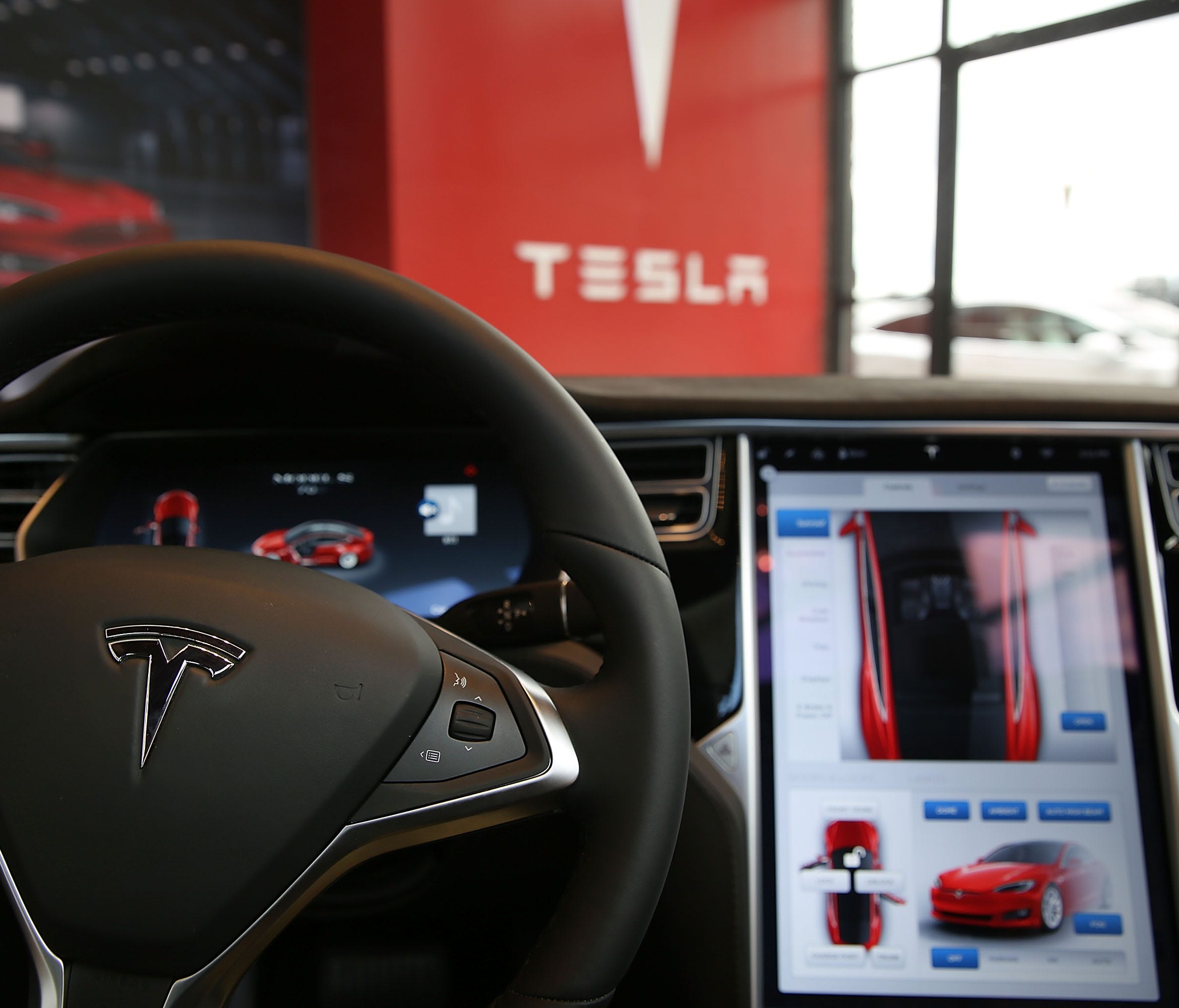 The inside of a Tesla vehicle is viewed as it sits parked in a new Tesla showroom and service center in Red Hook, Brooklyn on July 5, 2016 in New York City. The electric car company and its CEO and founder Elon Musk have come under increasing scrutin