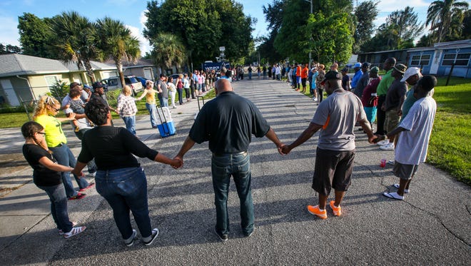 Community members and church leaders held a prayer vigil in the Harlem Lakes neighborhood to help bring peace to the community. They started at St. Mary Missionary Baptist Church and walked to Davis Ct to pray on the street days after two men were on this very street. 
