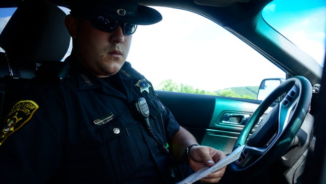 Sheriff’s deputy Matthew O’Brien, of the Binghamton area, fills out paperwork after pulling a person over on Rt. 81 southbound for speeding.