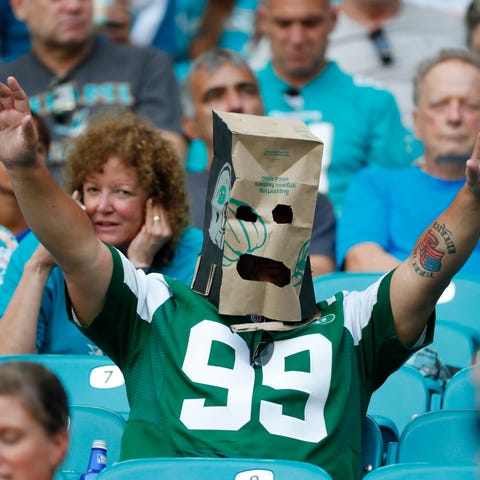 A New York Jets fan wears a paper bag after the te