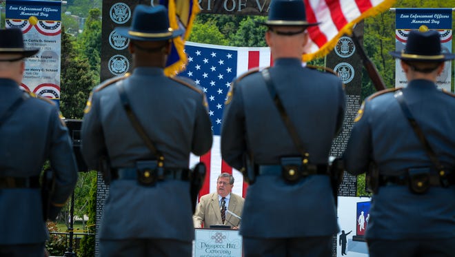Jack Sommer, CEO of Prospect Hill Cemetery, honors local police officers who gave their all in the line of duty during the Law Enforcement Officers Memorial Day Remembrance, Friday May 15, 2015. The annual service is planned at 1 p.m. Sunday, May 15, at Prospect Hill Cemetery.