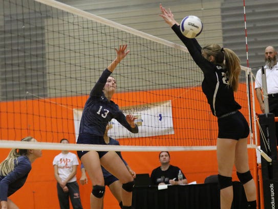 Colette Petric of IHA moves the ball over the net on