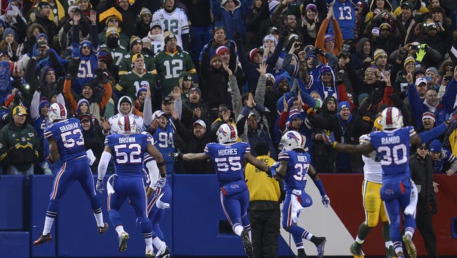 Buffalo Bills players celebrate in the end zone after causing a safety on the Green Bay Packers' running back Eddie Lacy in the fourth quarter during Sunday's game at Ralph Wilson Stadium in Orchard Park, N.Y.