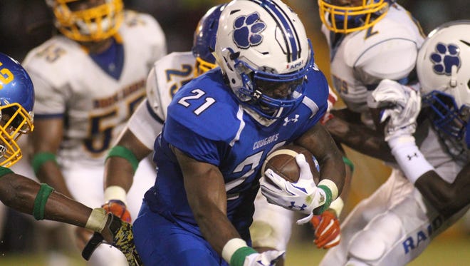 Godby running back Samondre Johnson carries the ball against Rickards in a game at Cox Stadium last week.