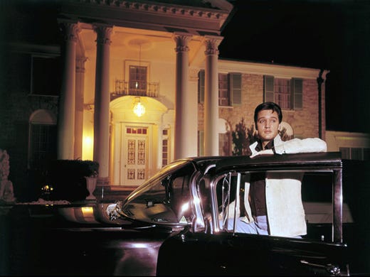 Elvis Presley posed with one of his cars outside Graceland