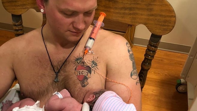 A Door County Medical Center nurse helped rig a suction cup fake nipple with milk coming from a tube attached to a vial of milk so that Maxamillian Neubauer of Sturgeon Bay was able to be the first to 'breastfeed' his newborn daughter.