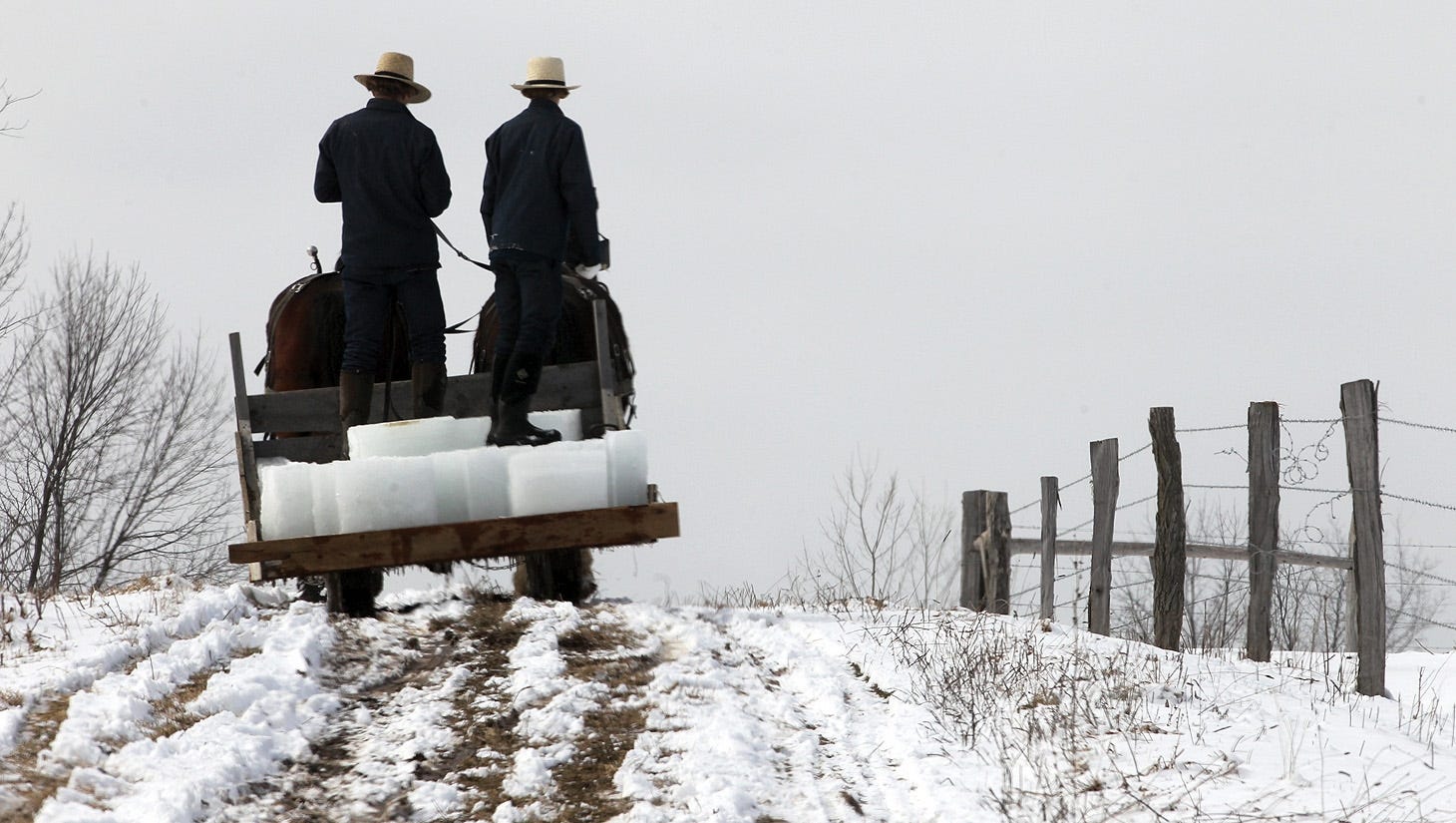 Two young Amish men head home with a load of ice that was harvested from a nearby pond in the town of Lyons, New York.