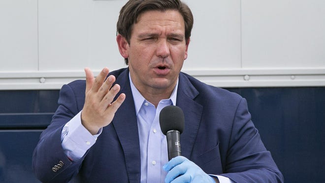 MIAMI -- Gov. Ron DeSantis, seen here speaking at the Miami Beach Convention Center on Wednesday, is under pressure to make jobless benefits retroactive as the state's newly unemployed continued to be mired in an unemployment system riddled with glitches and uncertainty.