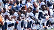 Broncos Bradley Roby (29) raises his arm as other players