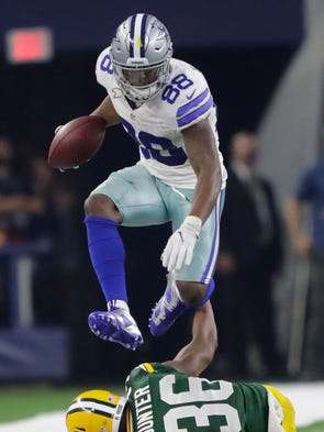 Dallas Cowboys' Dez Bryant hurdles Green Bay Packers'
