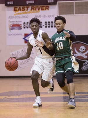 Elijah Proby (1) drives past Demarius Nickerson (10) during the basketball game between Catholic and Navarre at Navarre High School on Tuesday, December 5, 2017.