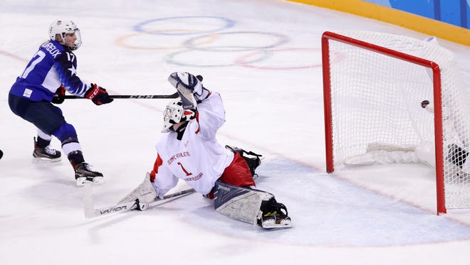 Jocelyne Lamoureux-Davidson of the U.S. scores against Russia's Valeria Tarakanova during the second period of their preliminary-round game Tuesday. The U.S. dominated, 5-0.