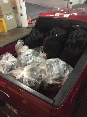 Four hundred pounds of marijuana, $100,000 in cash and three cars were seized by police early Wednesday, Aug. 27, 2015, after investigators were called to a building in the 9100 block of Pendleton Pike.