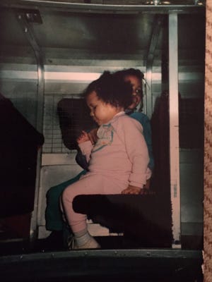 The columnist sits behind her sister Tiffany, getting ready to ride on the Midtown Plaza monorail, almost 30 years ago.