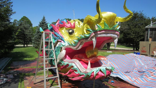 A dragon's head - from a previous event - gets work as Boerner Botanical Gardens prepares for this year's China Lights show.