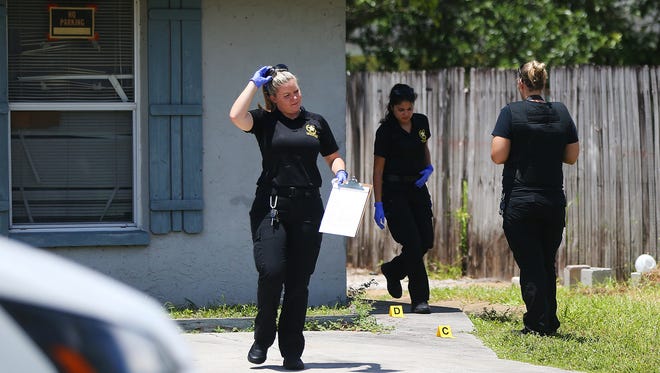 Lee County Sheriff’s Office technicians process the scene of a shooting Sunday on Seventh Street in south Fort Myers.