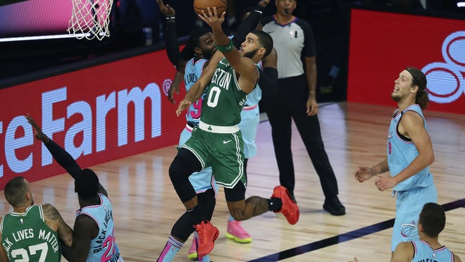 Boston's Jayson Tatum shoots against Miami's Jae Crowder during a game earlier this season. The two teams are set for another Eastern Conference finals battle that starts on Tuesday.