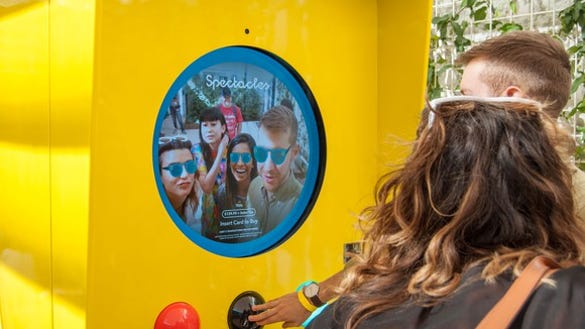 Two people watching a video on Snap's Spectacles