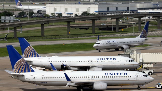 FILE - In this July 8, 2015, file photo, a United Airlines plane, front, is pushed back from a gate at George Bush Intercontinental Airport in Houston. (AP Photo/David J. Phillip, File)