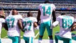 Dolphins players kneel with Jarvis Landry during the