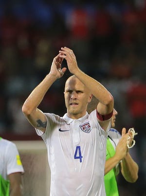 Michael Bradley, captain of the U.S. national soccer team applauds the crowd and U.S. supporters during a World Cup qualifier between Trinidad and Tobago and the U.S. Tuesday. The match ended in a 0-0 draw.