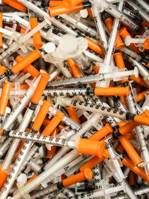 A plastic bin containing several thousand used syringes inside the mobile needle exchange unit at the Louisville Metro Department of Public Health and Wellness.May 2, 2016