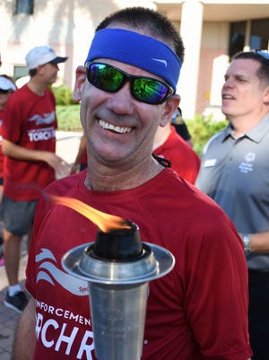Michael Lynch is the longtime torchbearer for the 4.8-mile Torch Run.
