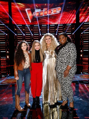 Team Kelly members Chevel Shepherd, left, Sarah Grace, Kelly Clarkson and Kymberli Joye are featured on the stage of "The Voice" at Universal Studios on Nov. 27. Shepherd and Grace, both of whom are among the final 10 competitors, have become good friends over the course of the season.