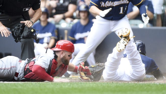 Brewers second baseman Jonathan Villar scores on Ryan Braun's double ahead of the tag of Tucker Barnhart in the first inning of Sunday's game against the Reds at Miller Park.