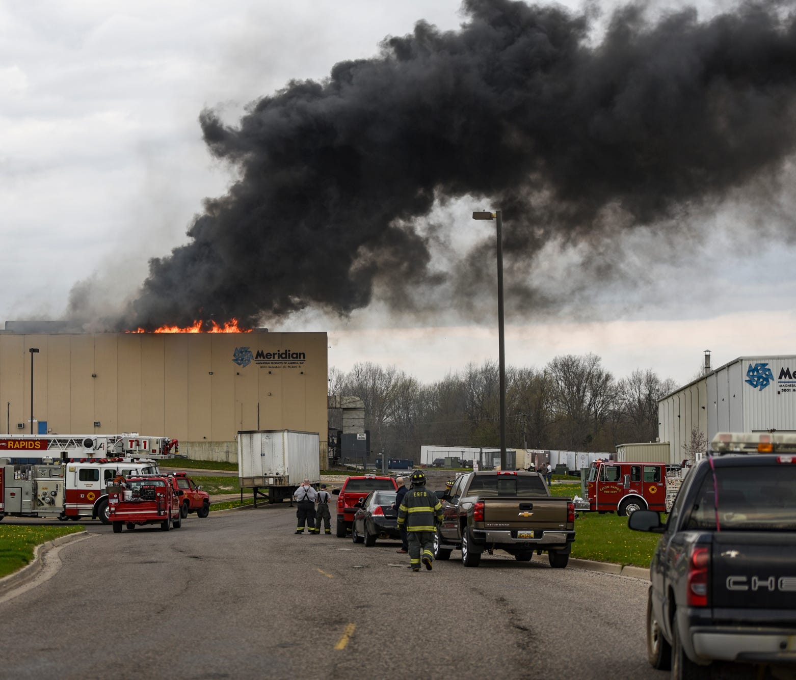 Firefighters wait for magnesium to burn out at a fire in Meridian Magnesium Products of America in Eaton Rapids, Michigan, Wednesday morning, May 2, 2018.