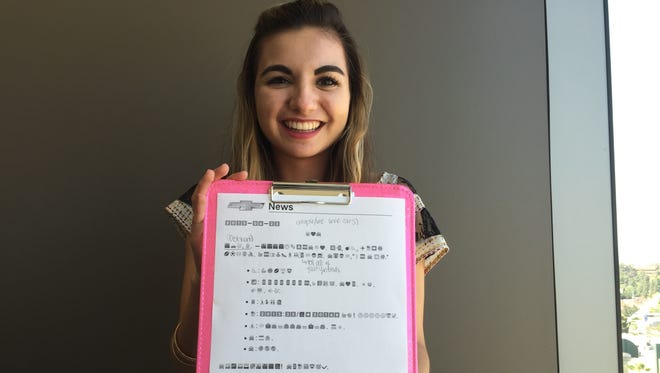 USA TODAY's Becca Smouse shows off her translation of Chevy's emoji press release