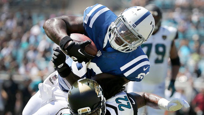 Indianapolis Colts Dwayne Allen runs over Jacksonville Jaguars Winston Guy Jr. for a second quarter touchdown. The Indianapolis Colts play the Jacksonville Jaguars Sunday, September 21, 2014, afternoon at EverBank Field in Jacksonville FL.