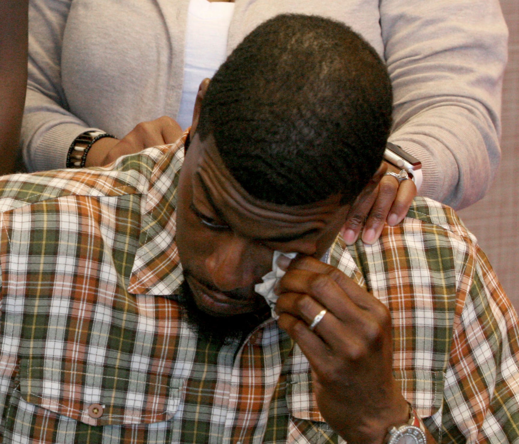 Odell Edwards wipes away tears as he sits with his wife, Charmaine, listening to their attorney Lee Merritt talk about the death of their son, Jordan Edwards, in a police shooting in Balch Springs, Texas.