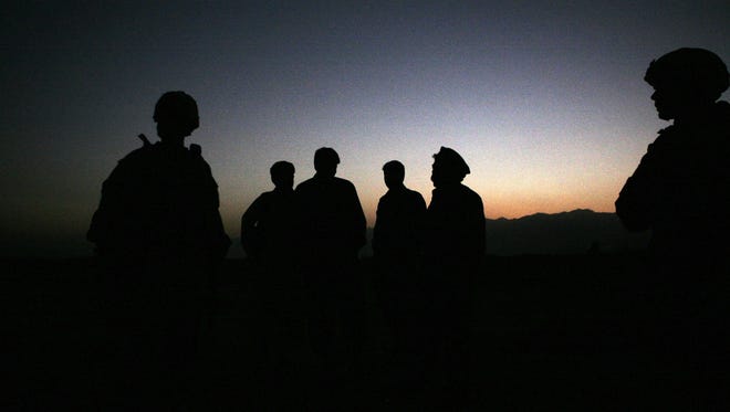 U.S. Army soldiers stand with Afghan policemen before a joint patrol of Qalanderkhail, outside of Bagram Air Field in Afghanistan.