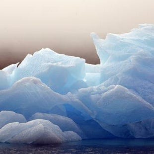 An iceberg floats in a bay off Ammassalik Island, Greenland, in July 2007. The recent decline of Arctic sea ice has played a critical role in recent cold and snowy winters in the USA.