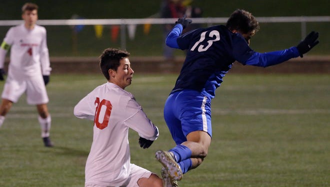 Mount Horeb's Caleb Guenther (left) and Delavan-Darien's Osvaldo Torres battle for control of the ball.