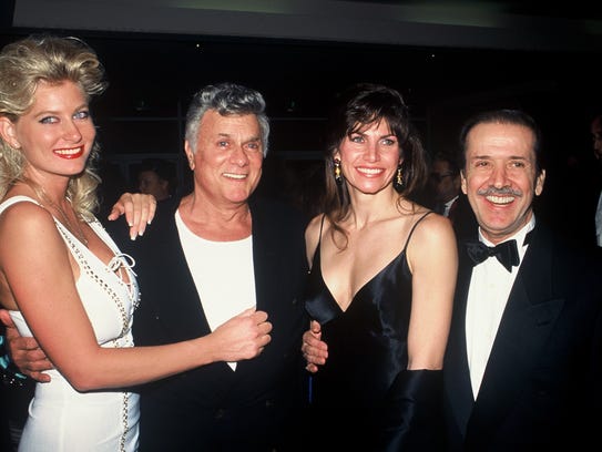 Tony Curtis, with an unidentified woman to his left,