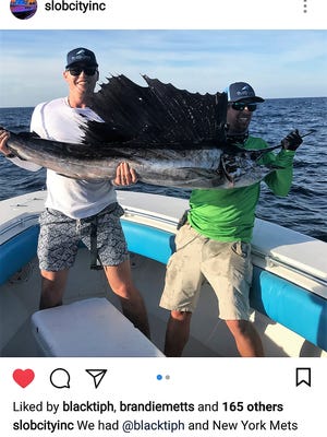 New York Mets outfielder Brandon Nimmo of Cheyenne, Wyo. (left) caught and released his first sailfish two weeks ago while fishing with Josh Jorgensen of West Palm Beach (right), of BlacktipH YouTube channel and Capt. Carl Torreson of Slob City charters in Port St. Lucie.