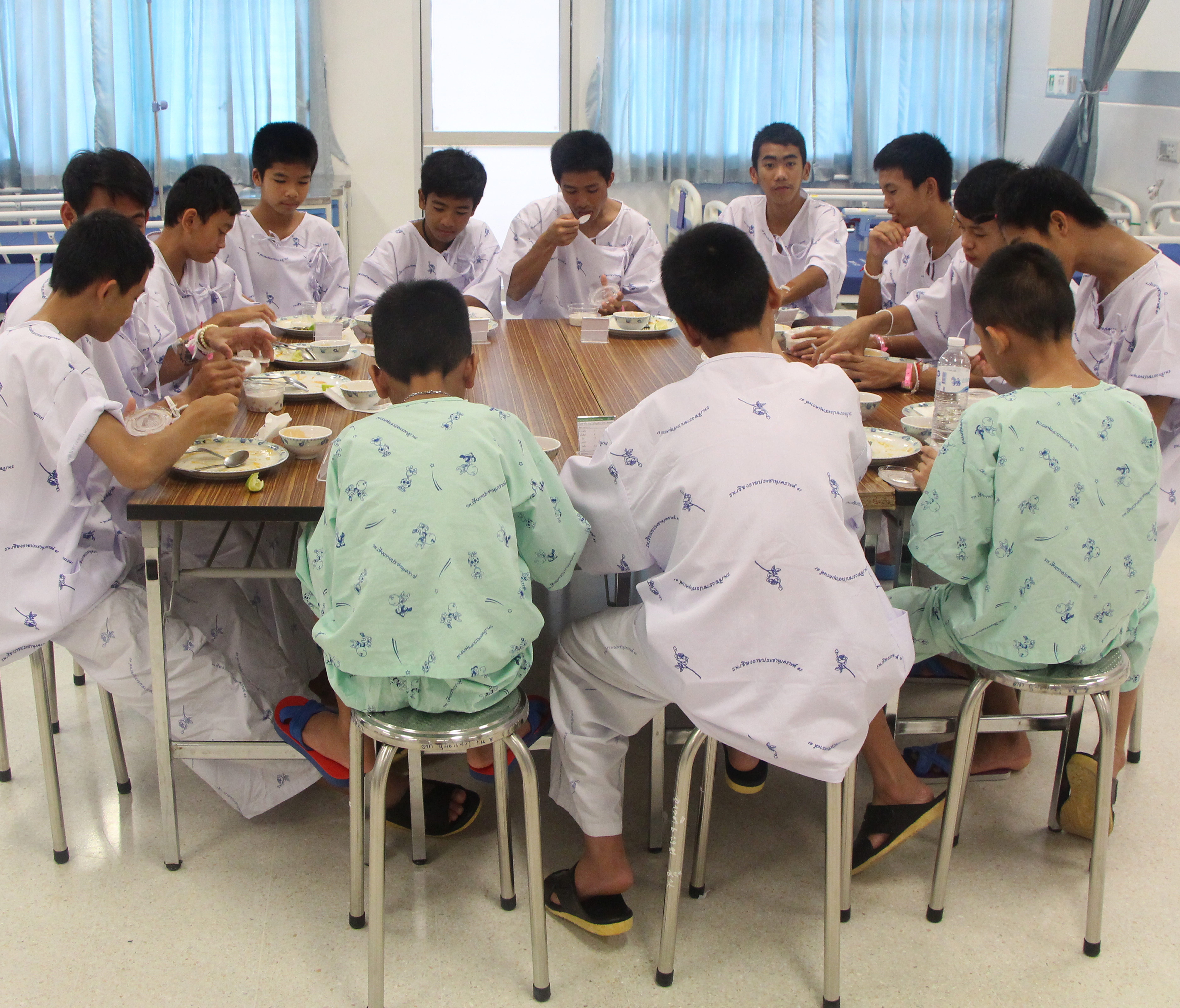 A handout photo made available by the Chiang Rai Prachanukroh Hospital and the Ministry of Public Health shows some of the 13 rescued soccer team members having a meal together in Chiang Rai province, Thailand on July 14.