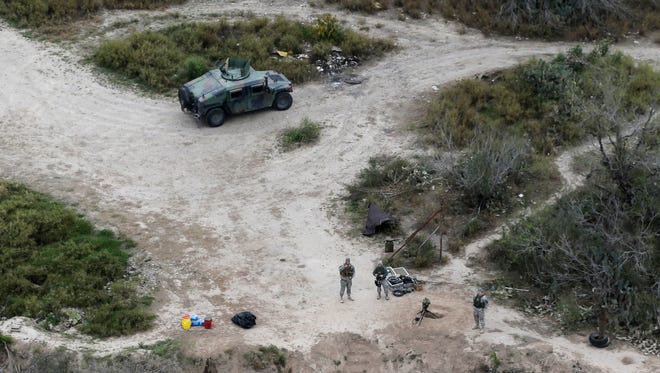 Members of the National Guard patrol along the Rio Grande at the Texas-Mexico border in Rio Grande City, Texas.